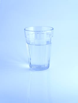 A glass of water on blue background