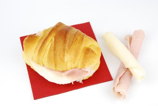 cheese and ham fresh croissant with red napkin isolated on white background