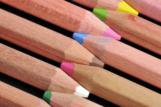 Colored pencils close up against black background