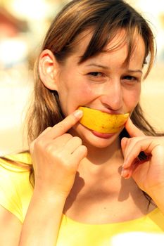 girl eating tasty and fresh orange in the sun