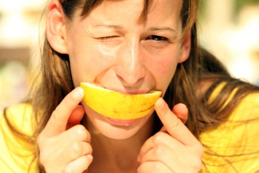 Girl eating fresh fruit by shining sun