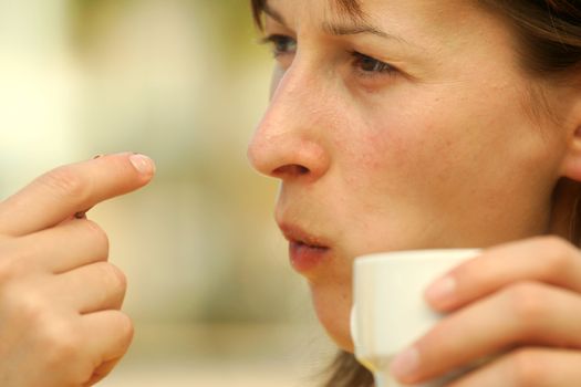 eating a cookie with cup coffee in restaurant