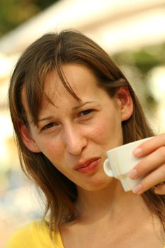 Woman drinking a cup coffee in the breakfast time