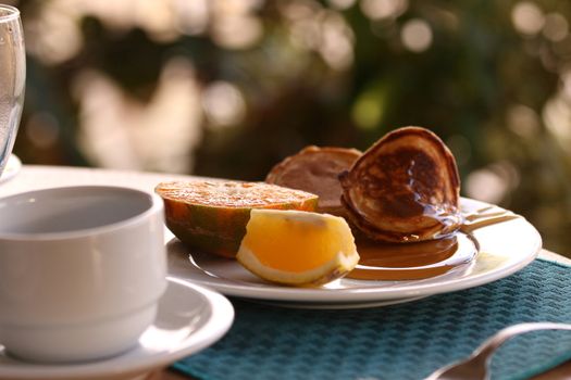 pancake with fresh fruits and honey on the table