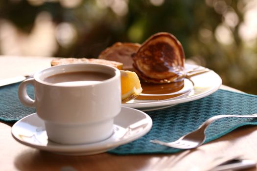 pancakes with a cup coffee and fresh fruits