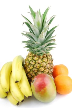 fresh fruits assortment (pineapple, orange, banana, mango) isolated on white background