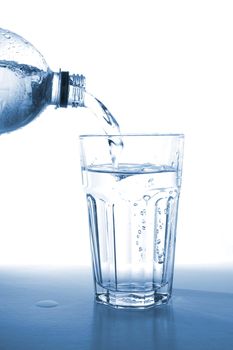 bottle of water isolated on white filling glass