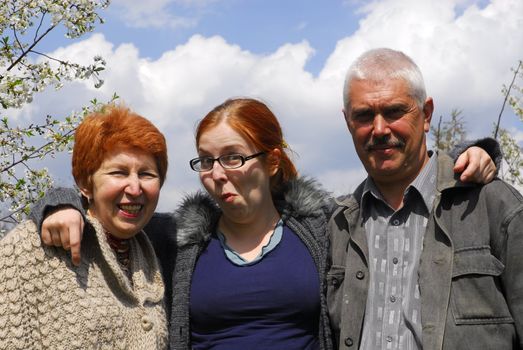 Senior couple with daughter on the nature 2