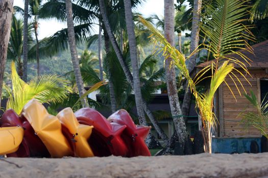 colorful kayaks lying on the sand beach