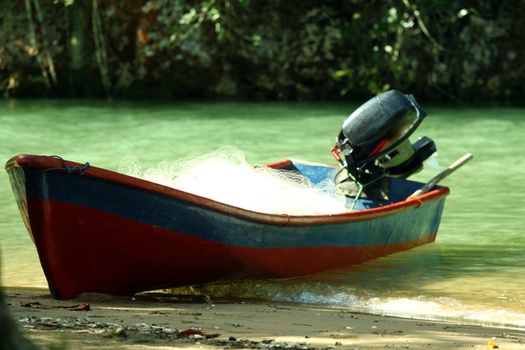 old motor boat on tropical beach