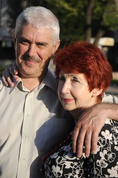 A happy senior couple outdoors. They are still in love after many years together.