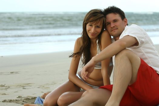 natural couple at the beach by sunset