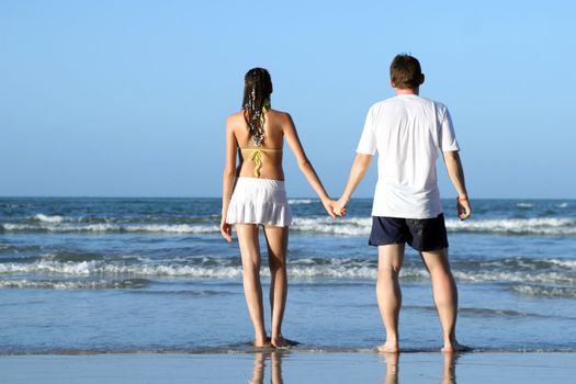 natural couple at the beach by sunset