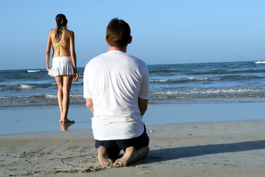 natural couple at the beach by sunset