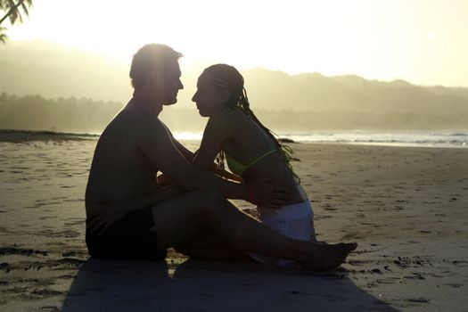 natural couple at the beach by sunset