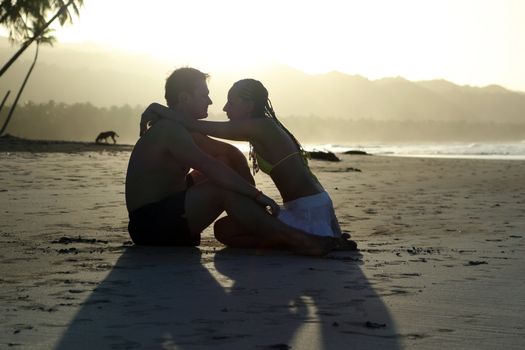 natural couple at the beach by sunset