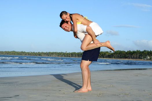 natural couple at the beach by sunset