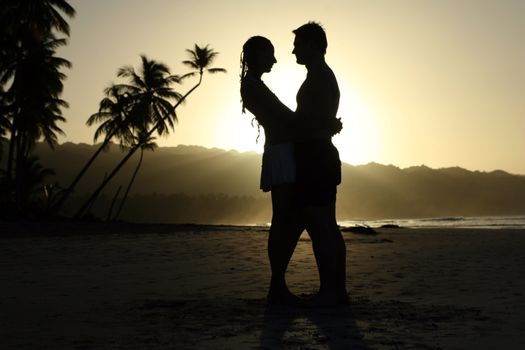 silhouette couple at the beach by sunset