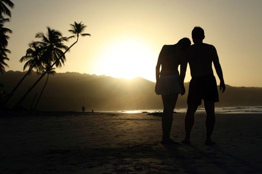 silhouette couple at the beach by sunset