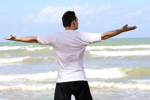 man doing workout exercises on the beach