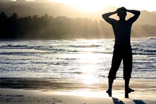 man on the beach by sunset