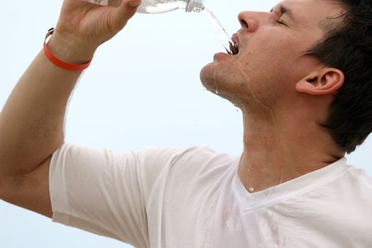 close up of a man drinking water after sport training