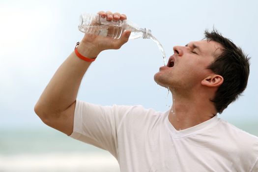 man drinking water after sport training