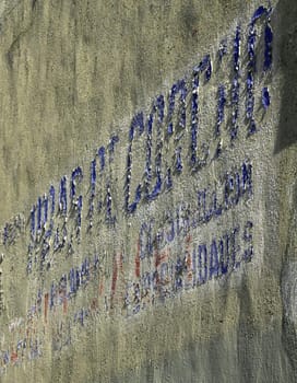 old crispy wall, blue and red letters falling down
