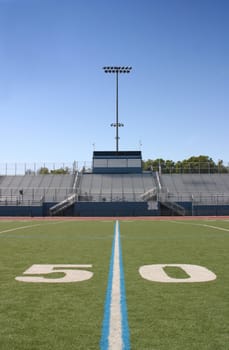 Green football field with large yard numbers.
