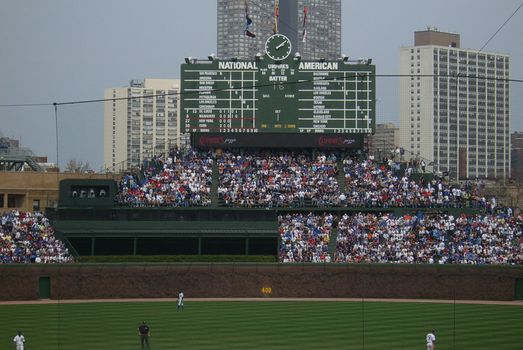 Chicago Cubs baseball players with vintage scoreboard and ivy