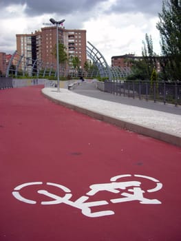 Cyclist line sign over a pedestrian bridge over M-30 highway in Madrid.