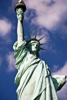 Statue Of Liberty On A Blue Clowdy Sky