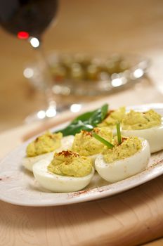 Deviled Eggs and Appetizers on a Decorative White Plate.