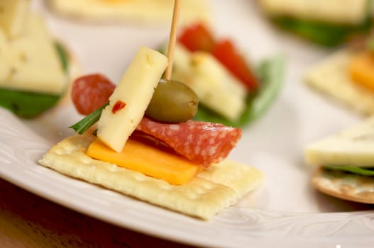 Cracker Appetizers with cheese, olive and pepperoni.