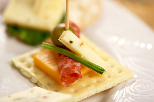 Cracker Appetizers with cheese, olive and pepperoni.