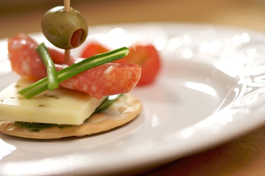 Cracker Appetizers with cheese, olive and pepperoni.