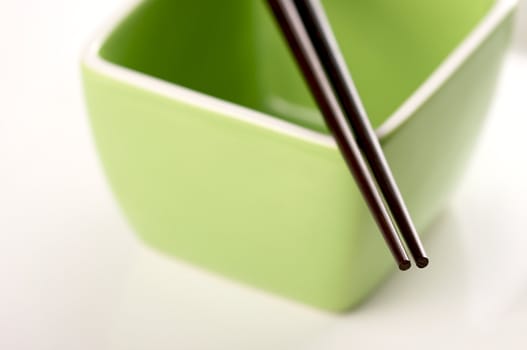 Chopsticks & Green Bowl on a white background.