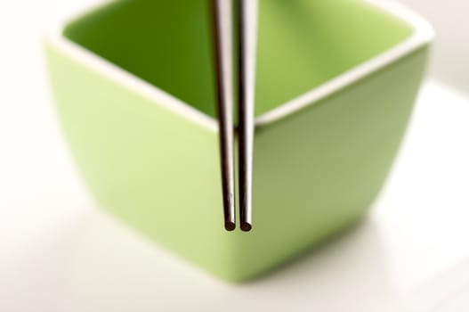 Chopsticks & Green Bowl on a white background.