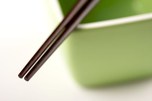 Chopsticks & Green Bowl on a white background.