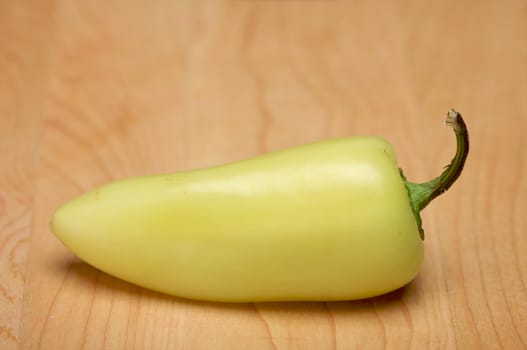 Yellow Hot Pepper on a Wood Cutting Board. Room for Copy.