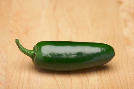 Jalapeno Pepper on a Wood Cutting Board - Room for Copy at the Top.