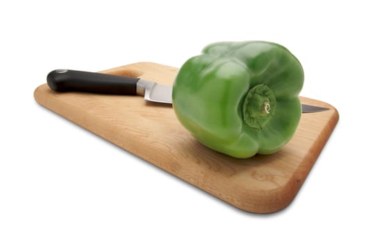 Green Bell Pepper and Knife on a Wood Cutting Board