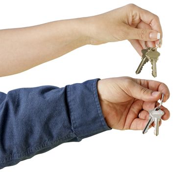 Man and Woman handing over house keys on a white background with clipping path.