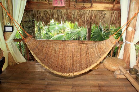 hammock made of native material hangging inside a hut
