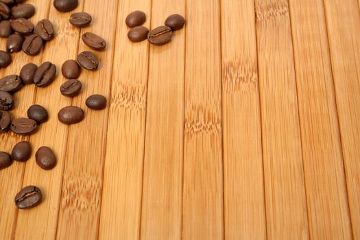 Grains of coffee on a carpet made of a bamboo 6