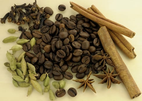 Coffee and spices on a wooden background