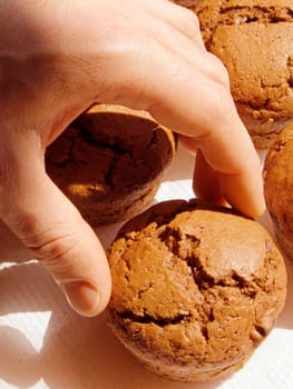 Hand chosing a chocolate muffin