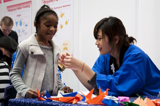 LONDON - JANUARY 30: Visitors in Origami workshop during the Tokyo Day.  January 30, 2010 in London, England.