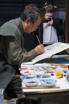 LONDON - JANUARY 30: Demonstration of silk hand-painting during the Tokyo Day.  January 30, 2010 in London, England.