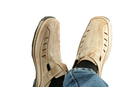 Human foot with brown leather shoes and jeans, isolated on white